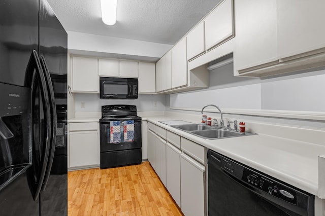 3252 Summerchase Cir, Augusta, GA 30909 - kitchen featuring black appliances, a sink, light countertops, light wood-style flooring, and a textured ceiling