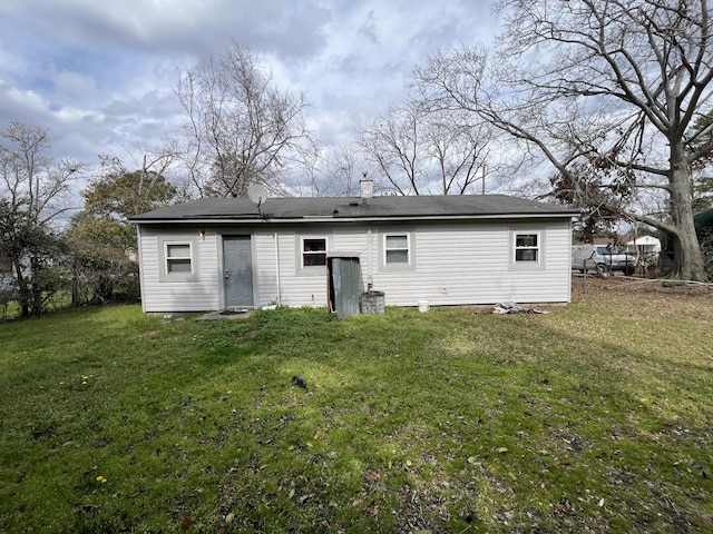 back of house with a yard