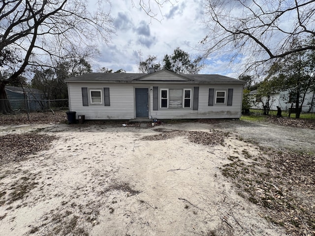 view of front of property featuring driveway and fence