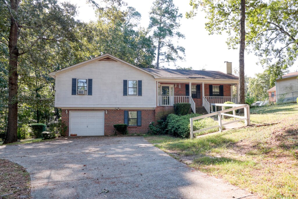 view of front facade featuring a porch and a garage