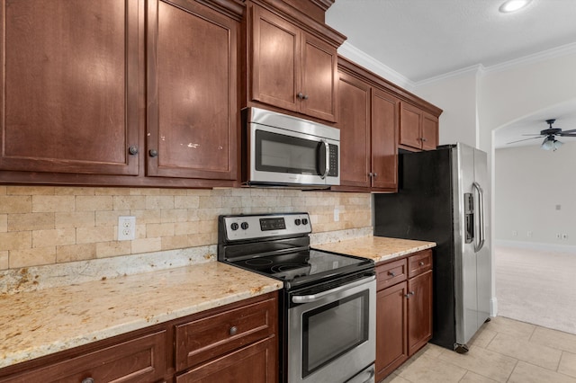 1606 Cedar Hill Dr, Grovetown, GA 30813 - kitchen featuring appliances with stainless steel finishes, ceiling fan, light colored carpet, crown molding, and light stone countertops