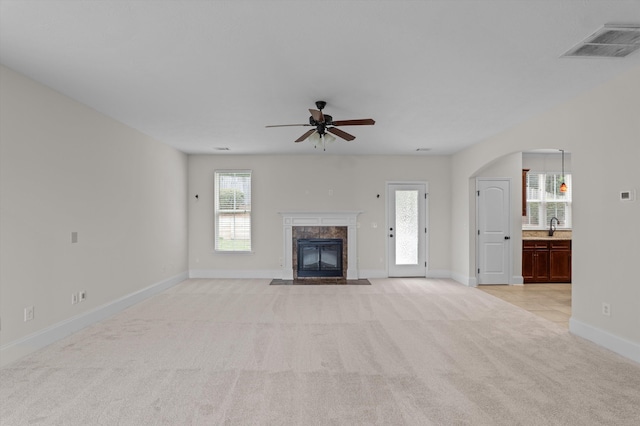 1606 Cedar Hill Dr, Grovetown, GA 30813 - unfurnished living room with ceiling fan, light carpet, a premium fireplace, and arched walkways