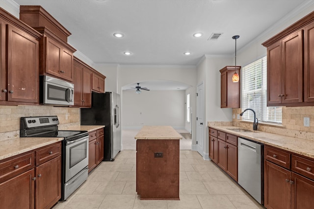 1606 Cedar Hill Dr, Grovetown, GA 30813 - kitchen with stainless steel appliances, a center island, a ceiling fan, backsplash, and arched walkways