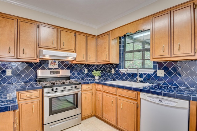 4520 Caliburn Way, Grovetown, GA 30813 - kitchen with stainless steel range with gas stovetop, white dishwasher, under cabinet range hood, tile countertops, and crown molding