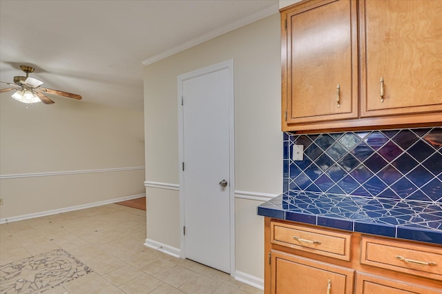 4520 Caliburn Way, Grovetown, GA 30813 - kitchen with tile countertops, ceiling fan, tasteful backsplash, crown molding, and brown cabinets