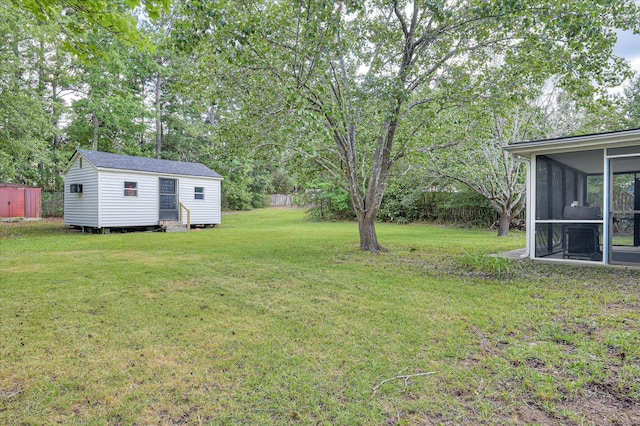 4520 Caliburn Way, Grovetown, GA 30813 - view of green lawn featuring a sunroom, an outdoor structure, and view of scattered trees