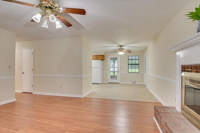 4520 Caliburn Way, Grovetown, GA 30813 - unfurnished living room featuring ceiling fan, light wood-style floors, and a brick fireplace
