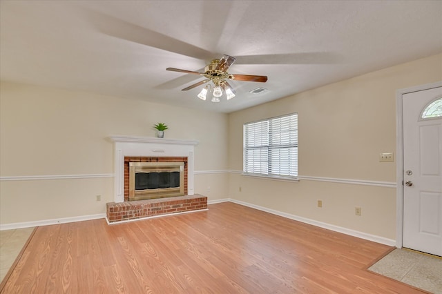 4520 Caliburn Way, Grovetown, GA 30813 - unfurnished living room with light wood-style flooring, a ceiling fan, plenty of natural light, and a brick fireplace