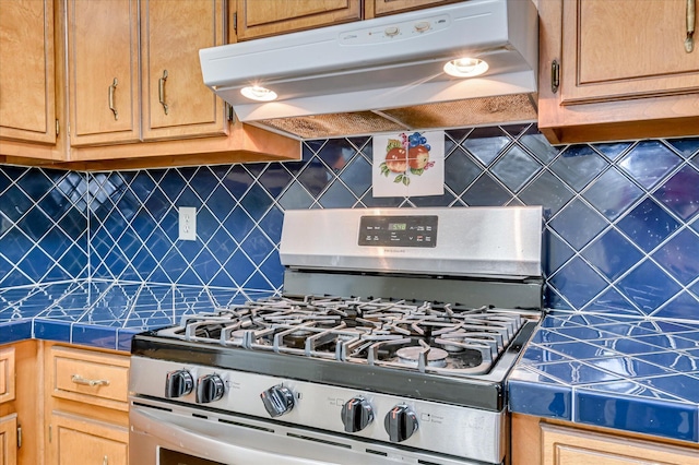 4520 Caliburn Way, Grovetown, GA 30813 - kitchen with gas range, under cabinet range hood, backsplash, and dark countertops