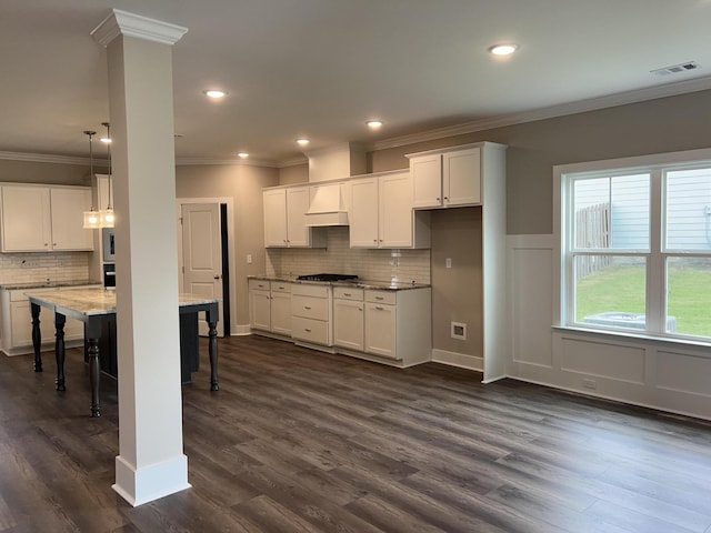 8048 Crossbow Lndg, Graniteville, SC 29829 - kitchen featuring ornamental molding, gas stovetop, a kitchen bar, backsplash, and white cabinetry