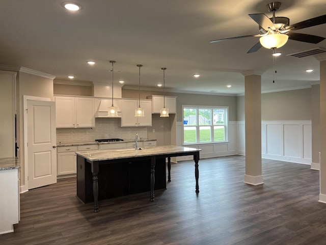 8048 Crossbow Lndg, Graniteville, SC 29829 - kitchen with ornate columns, crown molding, black gas cooktop, tasteful backsplash, and light stone counters