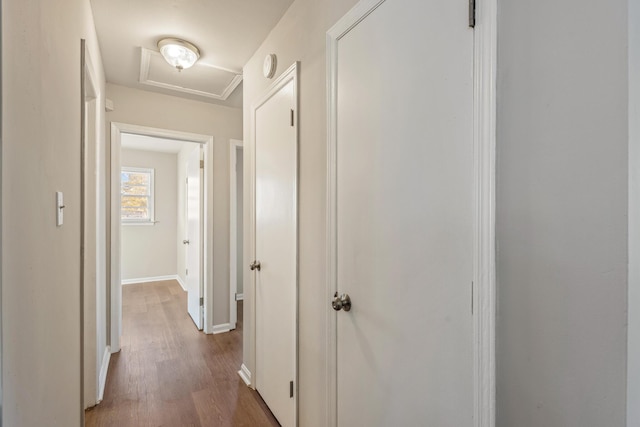 hallway with baseboards and wood finished floors