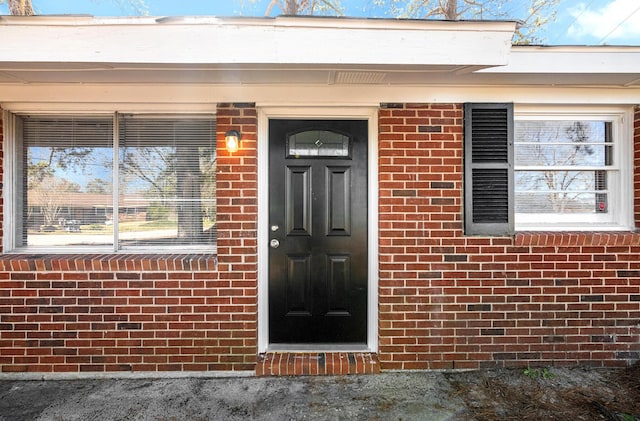 entrance to property with brick siding