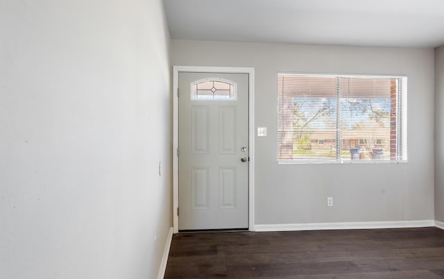 foyer featuring dark wood-style flooring and baseboards