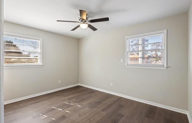 spare room with dark wood-style floors, ceiling fan, and baseboards