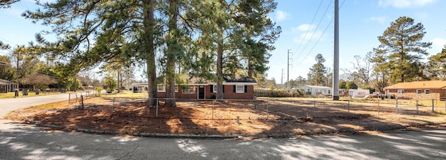 ranch-style home with fence