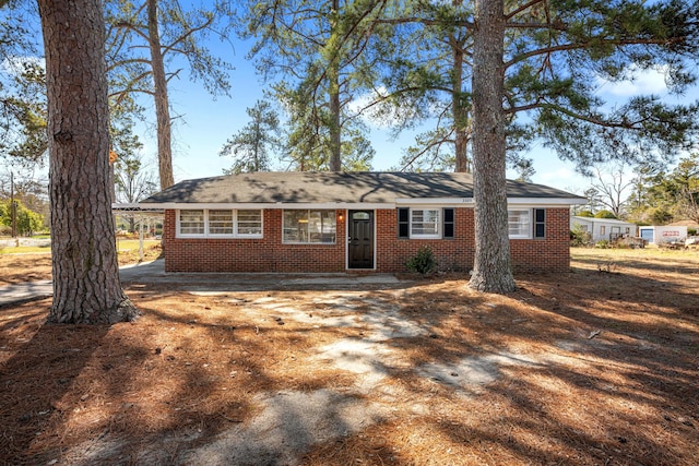 single story home featuring brick siding