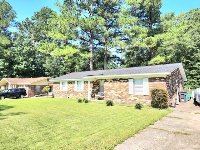 ranch-style home with a front lawn