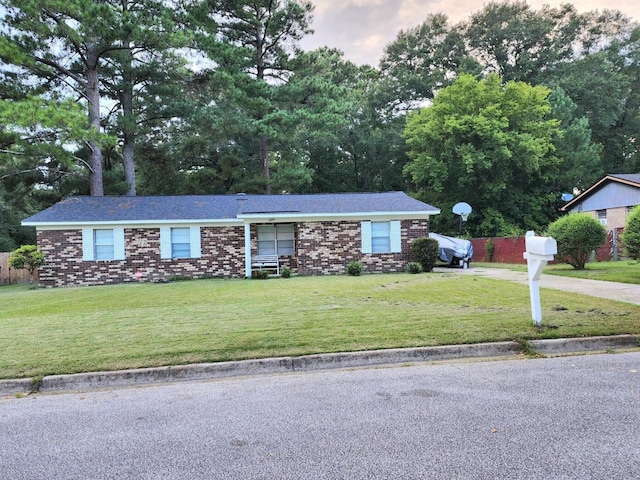 ranch-style home with a front lawn