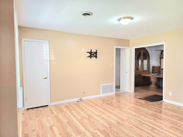 empty room with light hardwood / wood-style floors