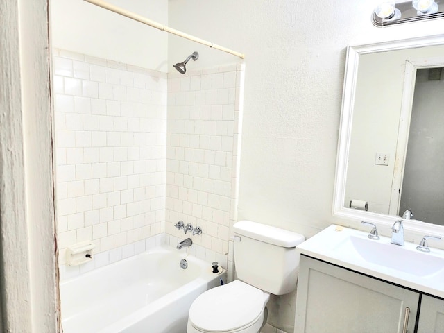 full bathroom featuring vanity, tiled shower / bath combo, and toilet