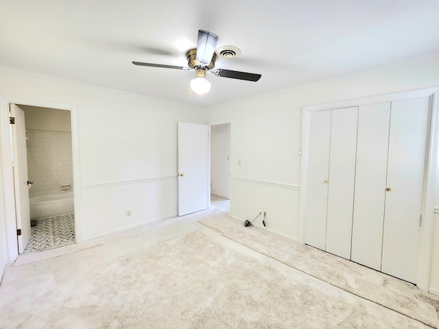 unfurnished bedroom with a closet, ensuite bathroom, and ceiling fan