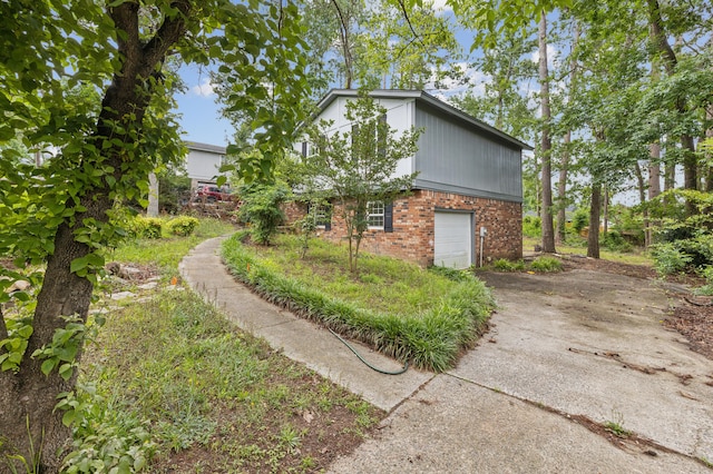 4572 Colonial Rd, Martinez, GA 30907 - view of side of home with brick siding, driveway, and a garage