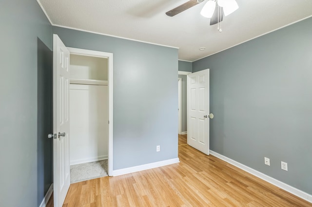 4572 Colonial Rd, Martinez, GA 30907 - unfurnished bedroom featuring light wood-style flooring, baseboards, a closet, ceiling fan, and crown molding