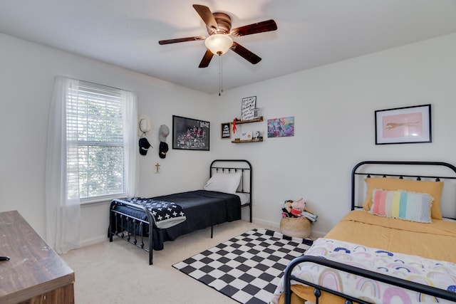 bedroom with baseboards, a ceiling fan, and light colored carpet