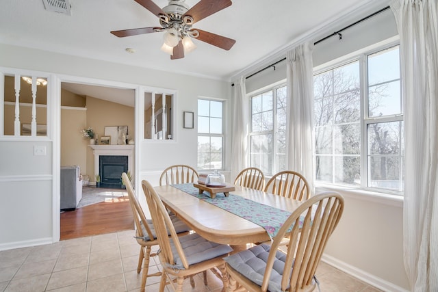 dining room with a healthy amount of sunlight, light tile patterned floors, and visible vents