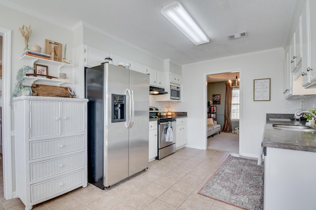 kitchen with dark countertops, white cabinetry, visible vents, and stainless steel appliances