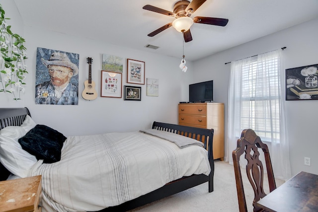 bedroom with ceiling fan, multiple windows, visible vents, and light colored carpet