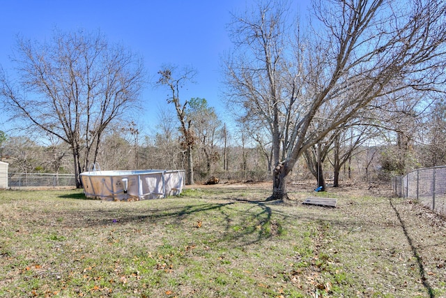 view of yard featuring a fenced backyard and an empty pool