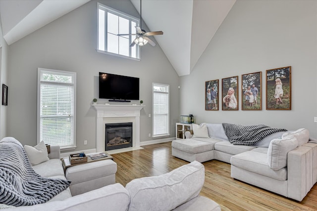 1176 Sumter Landing Cir, Evans, GA 30809 - living area featuring ceiling fan, high vaulted ceiling, wood finished floors, a fireplace with flush hearth, and healthy amount of natural light
