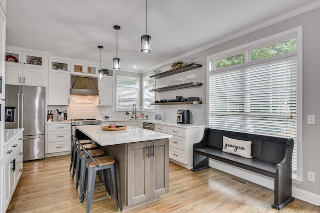 1176 Sumter Landing Cir, Evans, GA 30809 - kitchen with stainless steel appliances, custom exhaust hood, crown molding, backsplash, and light countertops