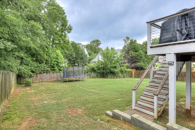 1176 Sumter Landing Cir, Evans, GA 30809 - fenced backyard with stairway and a trampoline