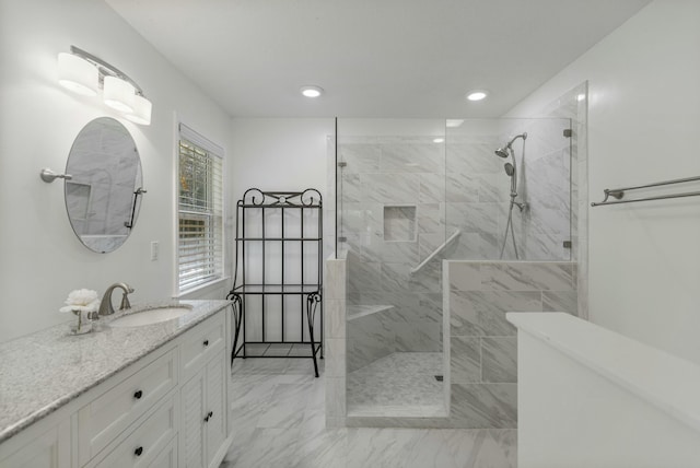 bathroom with recessed lighting, marble finish floor, vanity, and a walk in shower