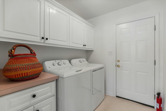 washroom with cabinet space and washing machine and dryer