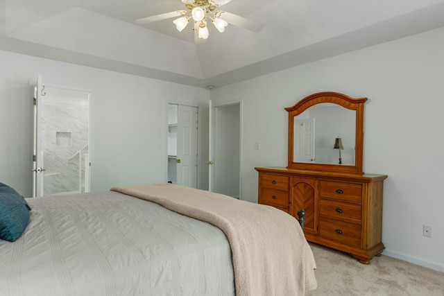 bedroom with light carpet, ensuite bathroom, baseboards, and a ceiling fan