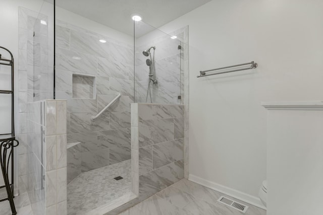bathroom with a walk in shower, baseboards, marble finish floor, and visible vents