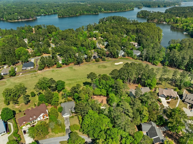 aerial view featuring a residential view, a wooded view, and a water view