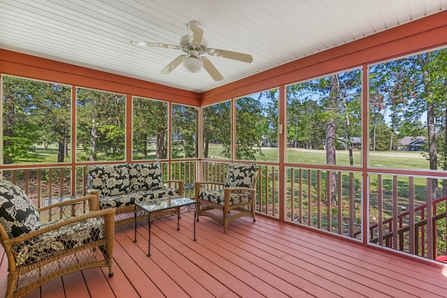 sunroom / solarium featuring a ceiling fan and an outdoor hangout area