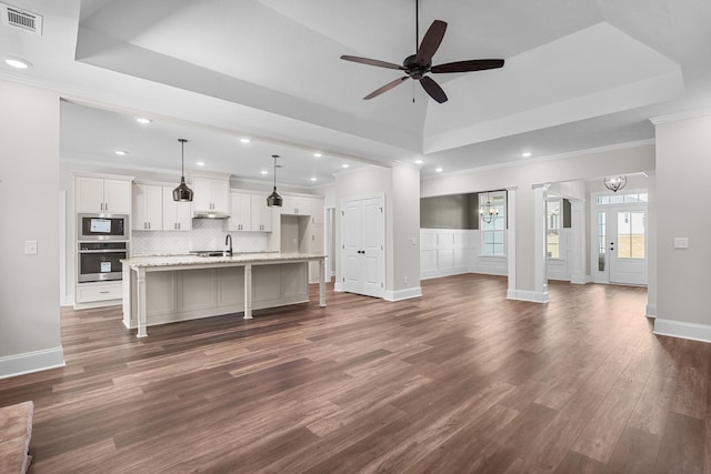 1253 Elbron Dr, Augusta, GA 30909 - unfurnished living room with a raised ceiling, dark wood-type flooring, ceiling fan, crown molding, and recessed lighting