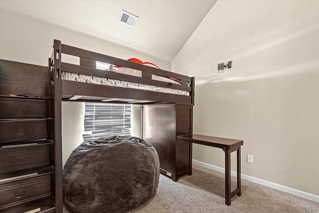 carpeted bedroom with vaulted ceiling