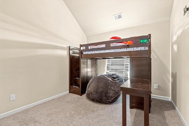 carpeted bedroom with vaulted ceiling