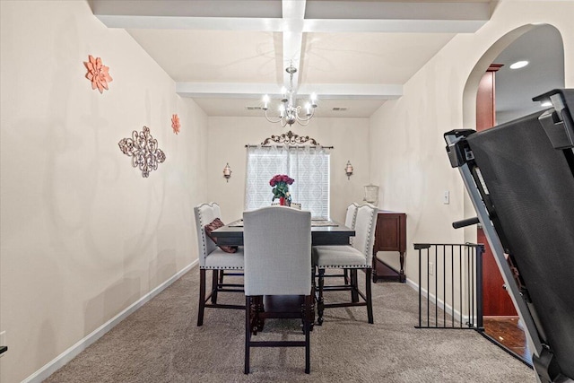 dining space with beamed ceiling, carpet floors, and an inviting chandelier