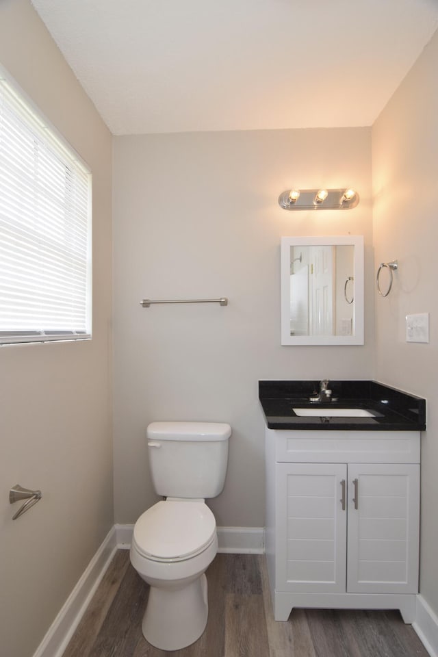 3528 Bullock Ave, Augusta, GA 30906 - bathroom with wood finished floors, vanity, toilet, and baseboards