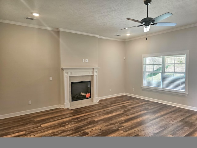 unfurnished living room featuring crown molding, baseboards, dark wood-style flooring, and a tiled fireplace