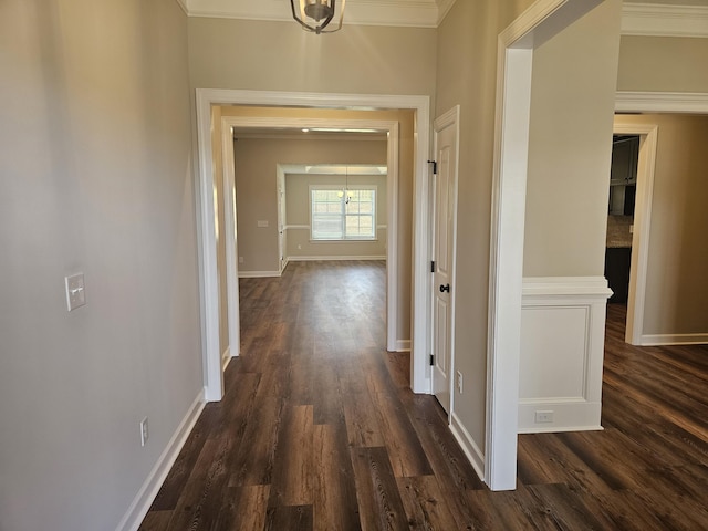 corridor with dark wood-style flooring and baseboards