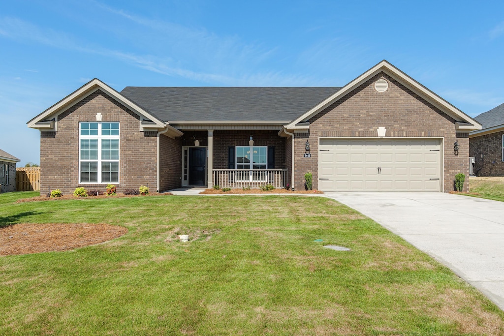 view of front facade featuring covered porch, a garage, concrete driveway, brick siding, and a front yard